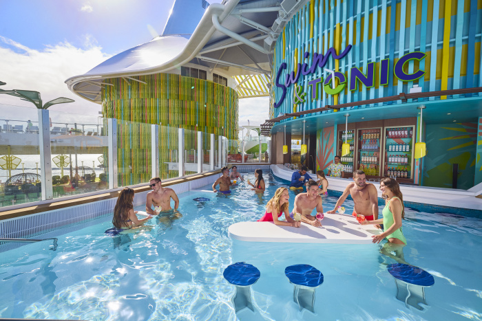 On Icon of the Seas, Swim & Tonic in Chill Island is Royal Caribbean's first swim-up bar at sea. Vacationers can have a sip while they take a dip and sit back at this vibrant spot, with in-water loungers and tables, a whirlpool and more.